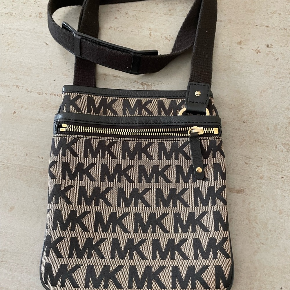 Michael Kors MK design crossbody bag. Snap close on main compartment